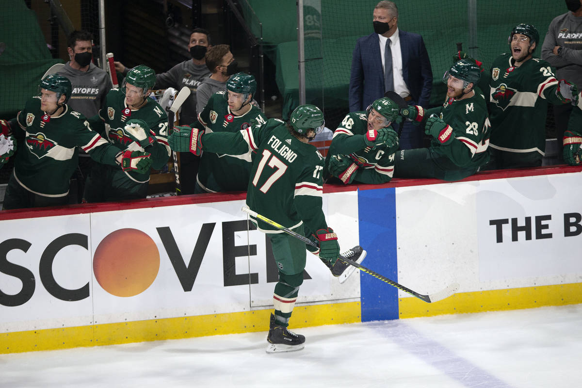 Minnesota Wild's Marcus Foligno (17) is congratulated by teammates on the bench after his goal ...