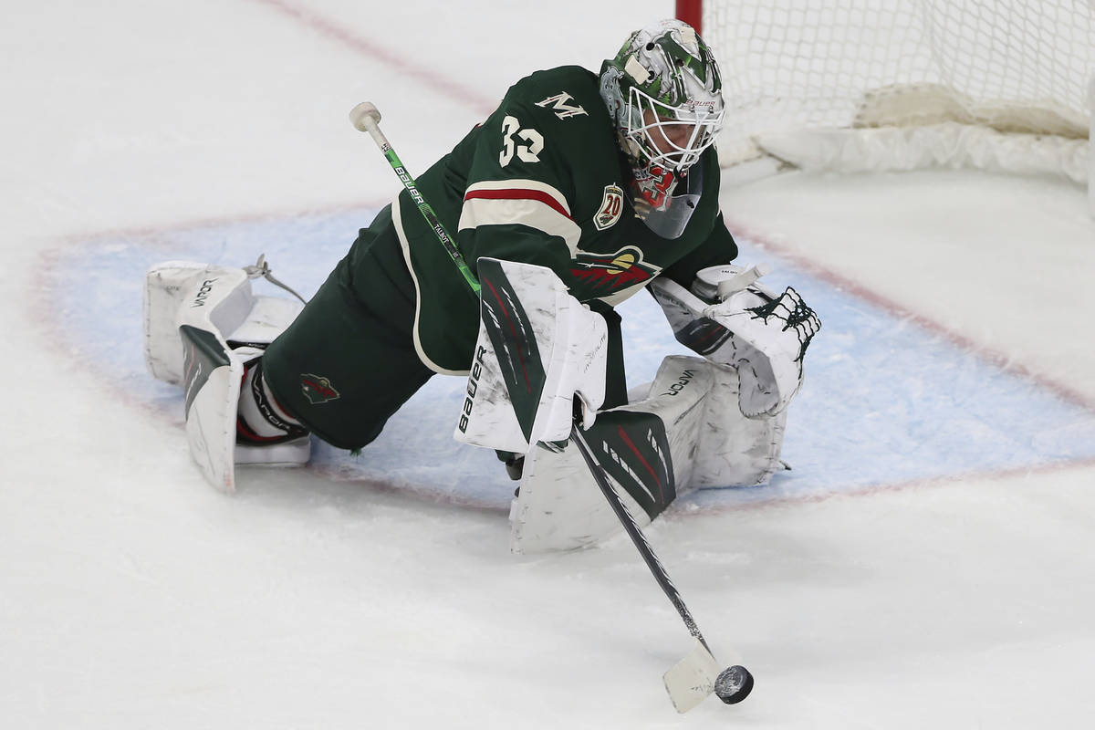 Minnesota Wild goalie Cam Talbot hits the puck away from the net during the third period in Gam ...