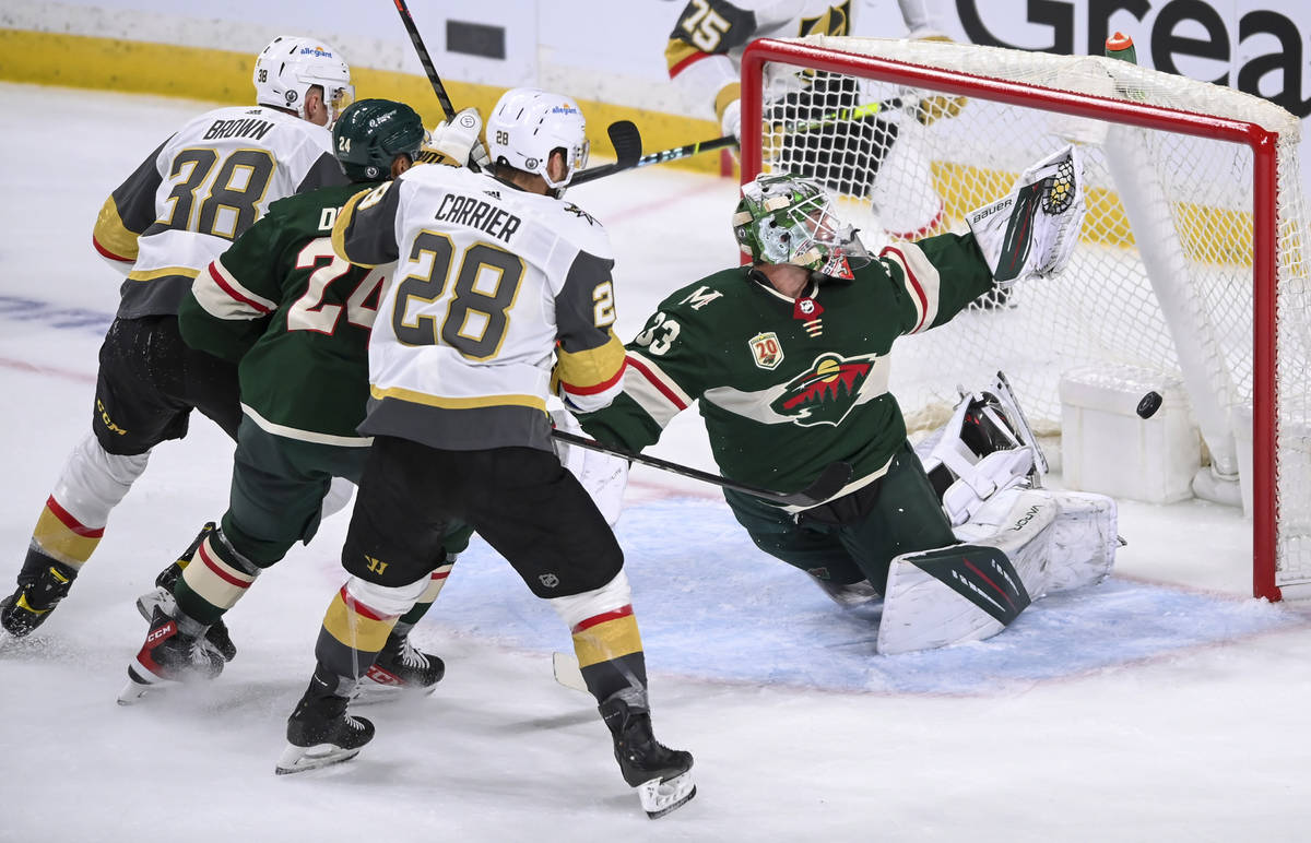 A shot by Vegas Golden Knights center Patrick Brown (38) goes past the glove of Minnesota Wild ...
