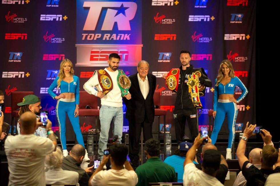 WBC and WBO junior welterweight champion Jose Ramirez, second from left, Top Rank promoter Bob ...