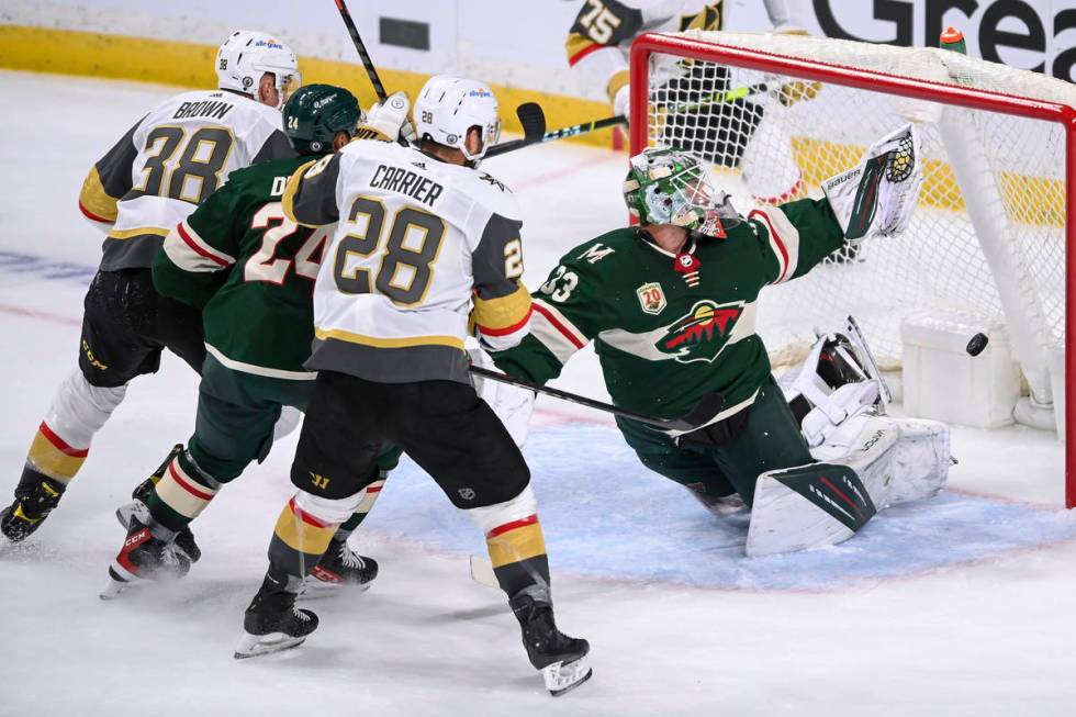 A shot by Vegas Golden Knights center Patrick Brown (38) goes past the glove of Minnesota Wild ...