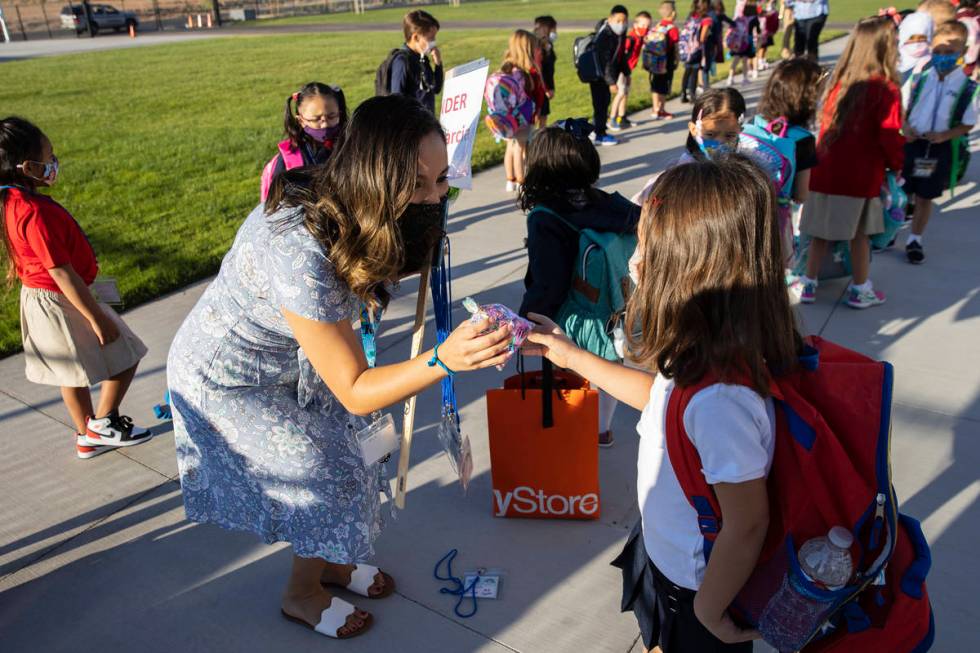 Mercedes Garcia, kindergarten teacher, receives a gift from her student, Alisea Nikolova, 5, at ...