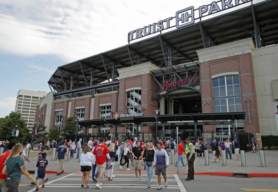 Fans make their way into Truist Park for the baseball game between the Atlanta Braves and the P ...