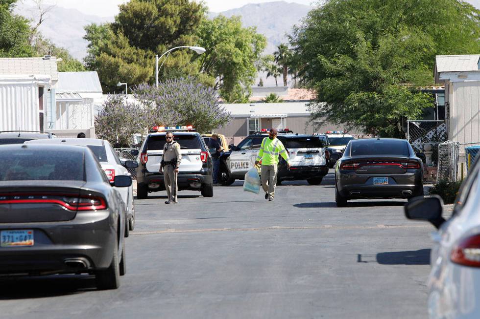 Police investigate a homicide Saturday morning, May 22, 2021, near the 3200 block of North Nell ...