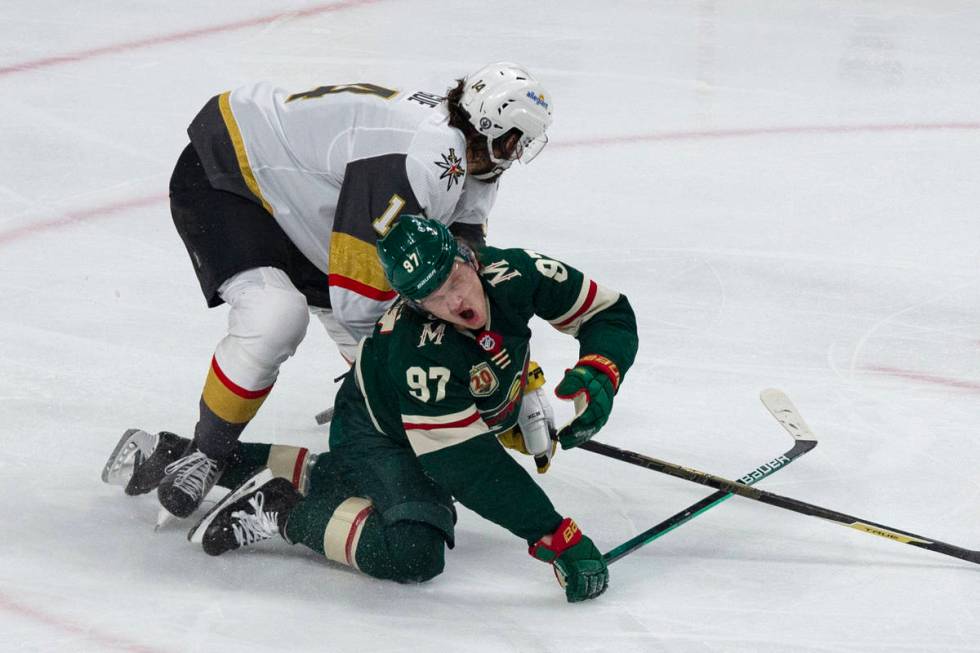 Minnesota Wild left wing Kirill Kaprizov (97) is hit by Vegas Golden Knights defenseman Nicolas ...