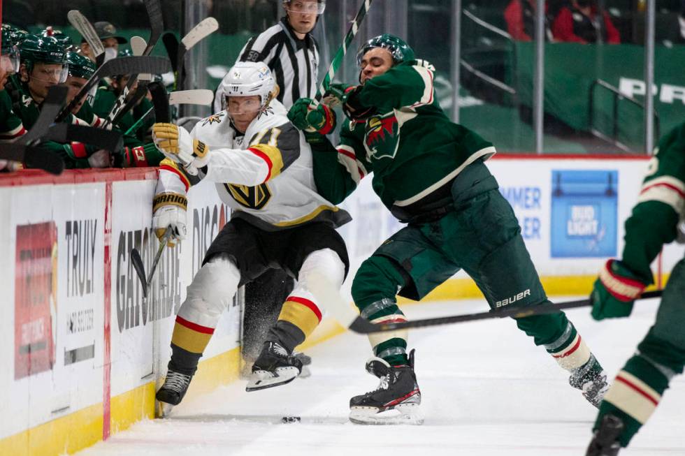 Minnesota Wild left wing Jordan Greenway (18) hits Vegas Golden Knights center William Karlsson ...