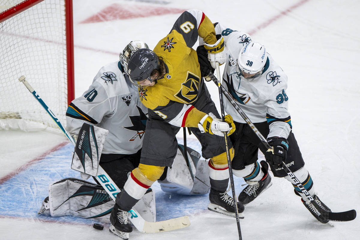 Golden Knights center Cody Glass (9) looks to get the puck into the net past San Jose Sharks go ...