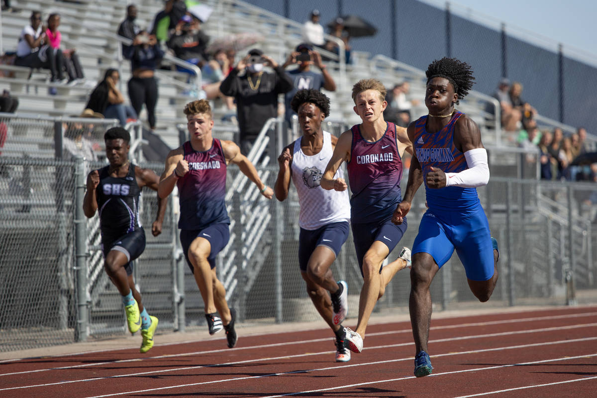 Bishop Gorman's Zachariah Branch, right, runs the boys 100 meter dash, and wins, during the cla ...
