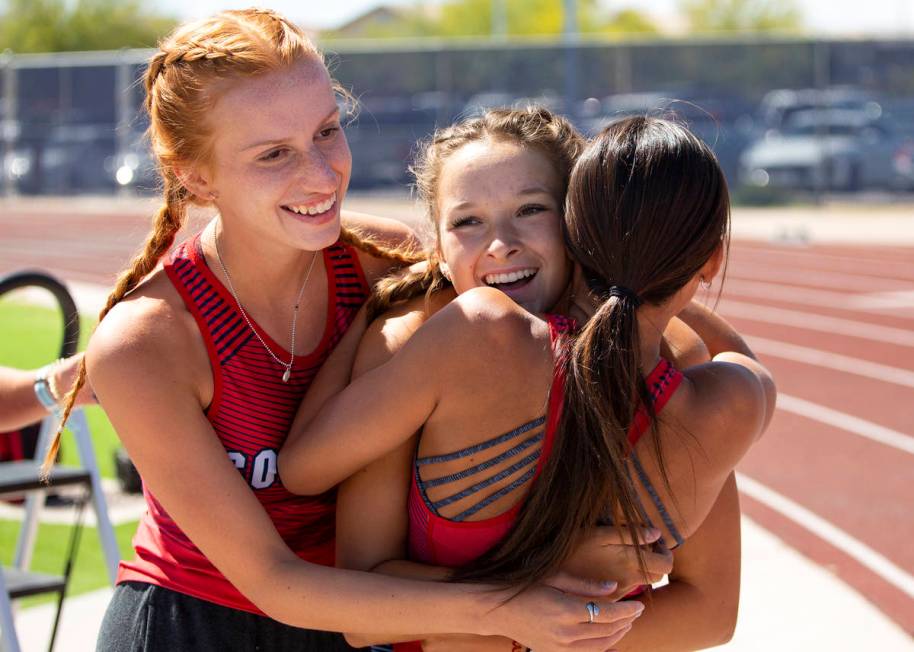 Coronado's Erin Shannon, center, is hugged by her teammates after winning the girls 800 meter r ...