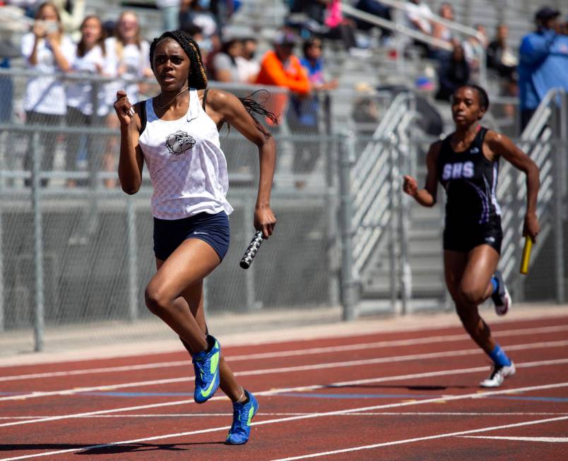 Centennial's Xiamara Young, left, competes in the girls 4x400 race during the class 5A Southern ...