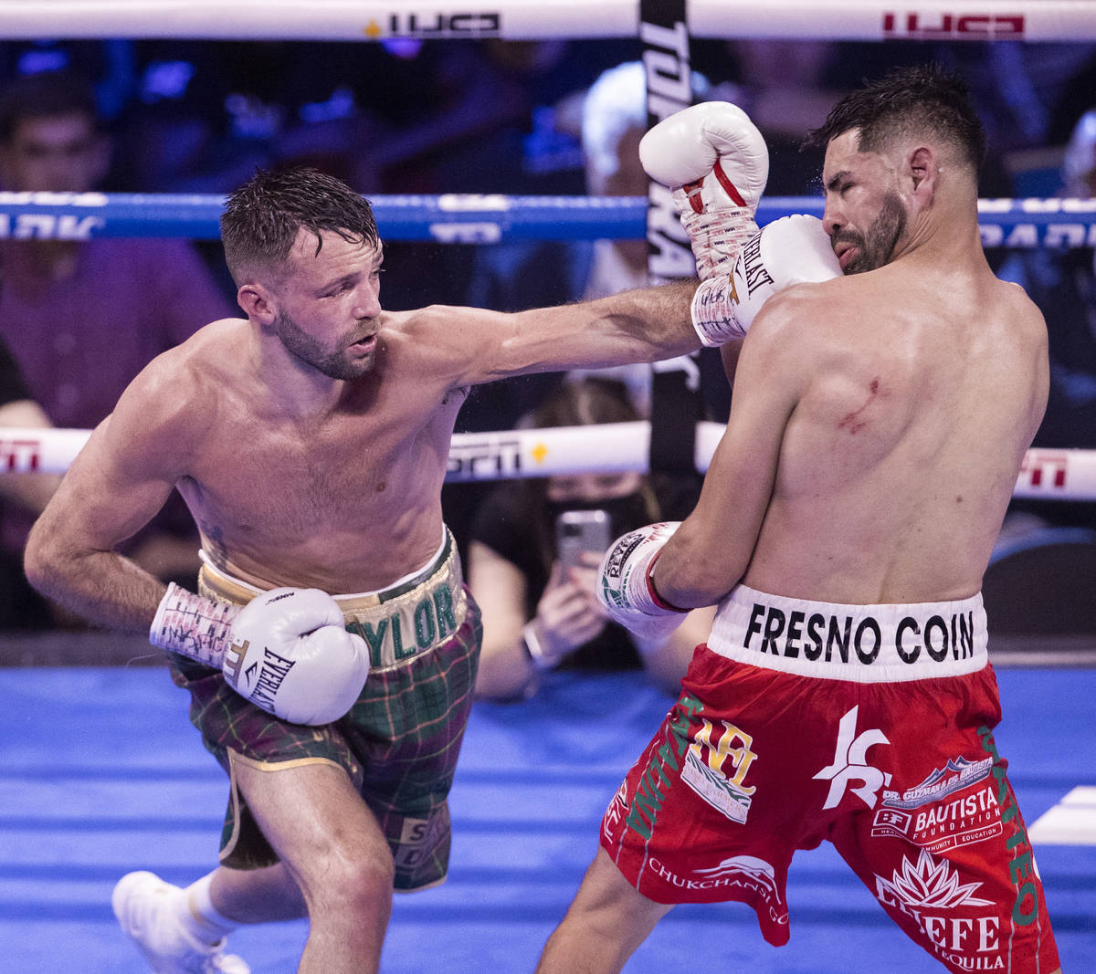 Josh Taylor, left, hits JosŽ Ram’rez during the 11th round of their junior welterw ...