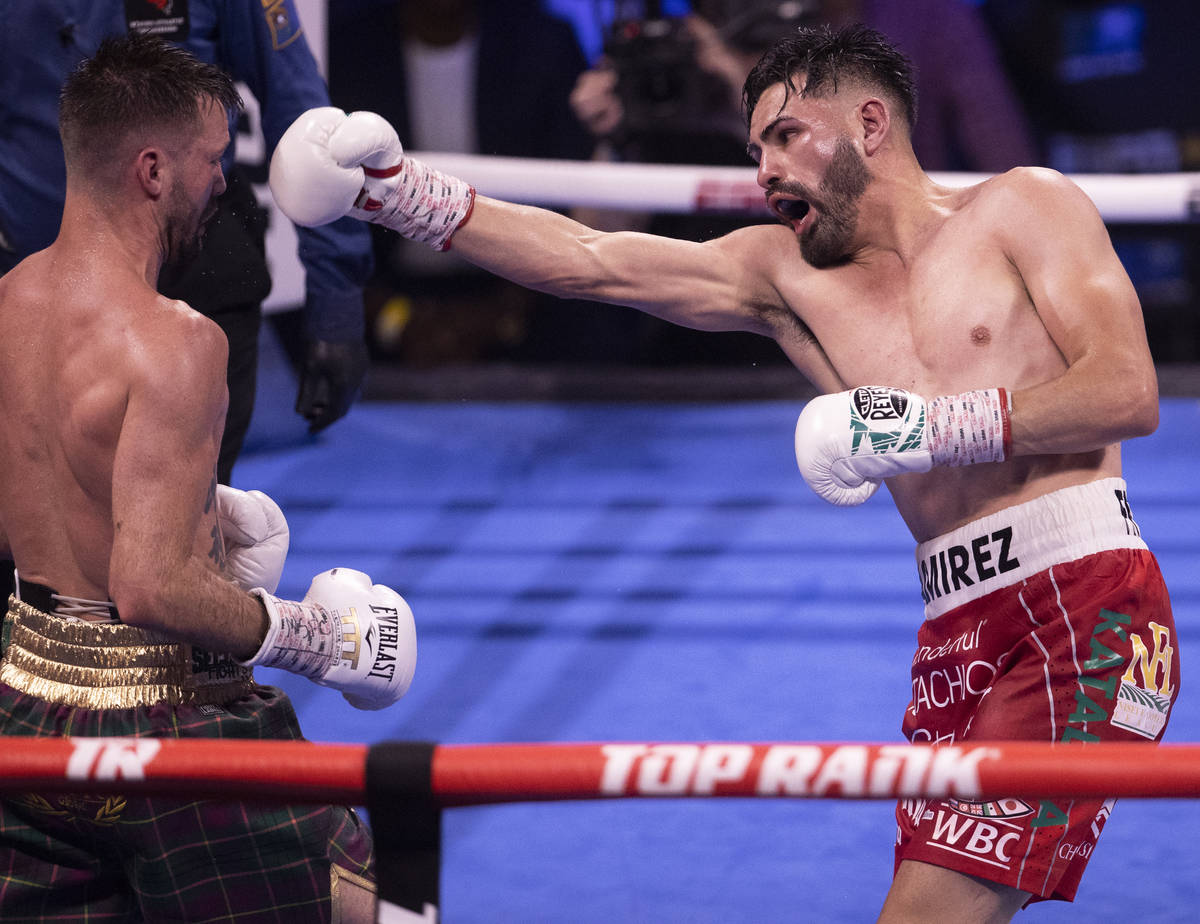 José Ramírez, right, throws a right hook at Josh Taylor during the 4th round of thei ...