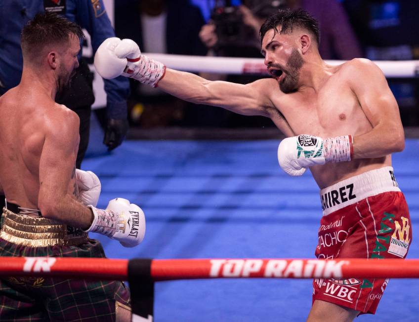 José Ramírez, right, throws a right hook at Josh Taylor during the 4th round of thei ...