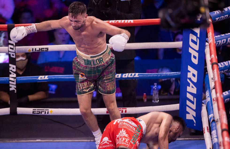 Josh Taylor, left, knocks down José Ramírez during the 6th round of their junior welt ...