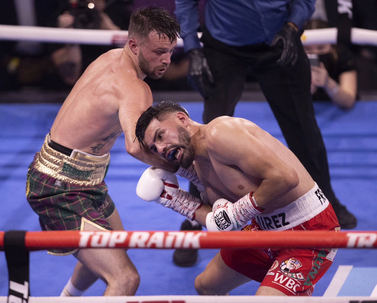 Josh Taylor, left, hits JosŽ Ram’rez during the 4th round of their junior welterwe ...