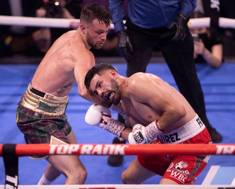 Josh Taylor, left, hits JosŽ Ram’rez during the 4th round of their junior welterwe ...