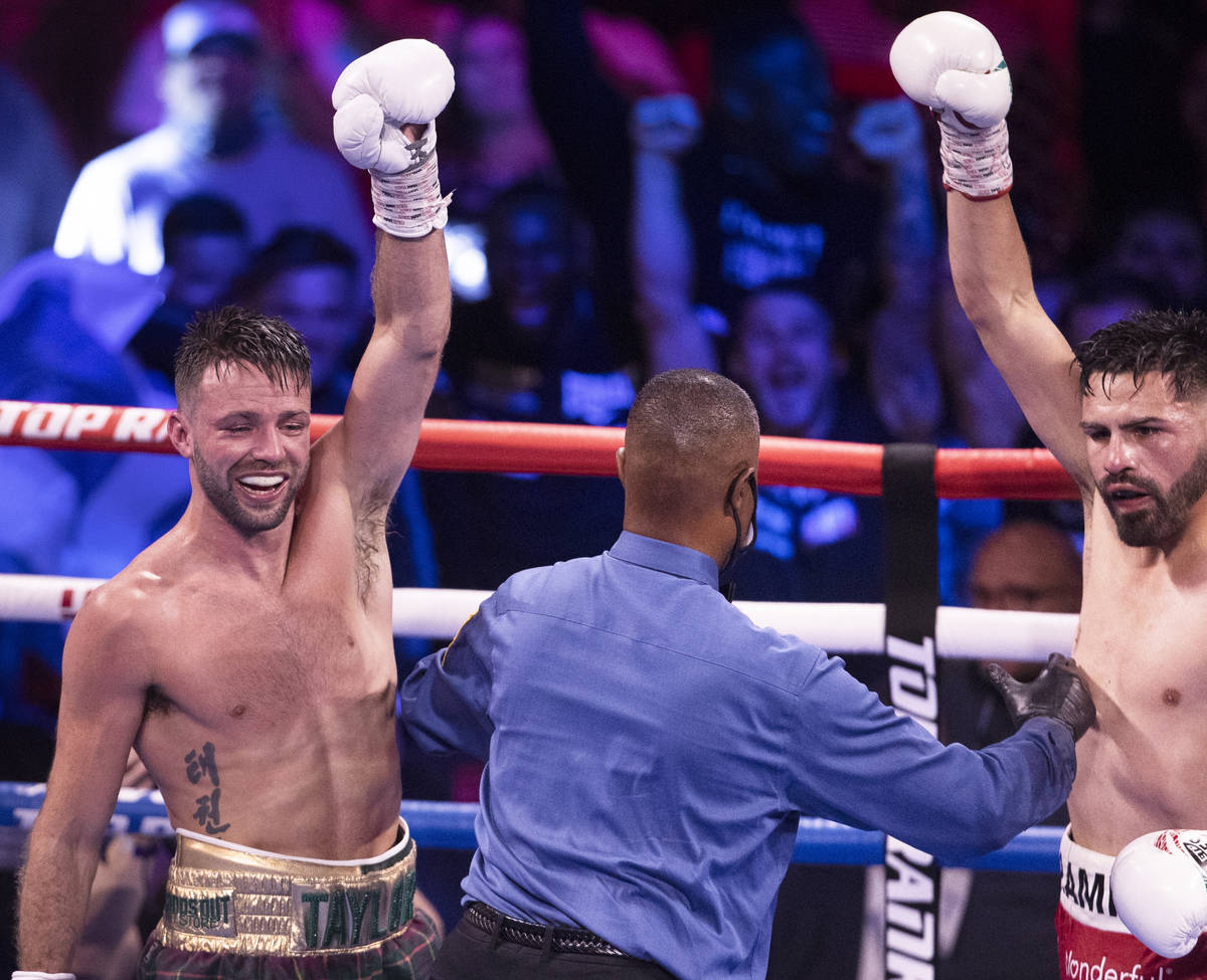 Josh Taylor, left, and JosŽ Ram’rez celebrate at the end of the 12th round of thei ...