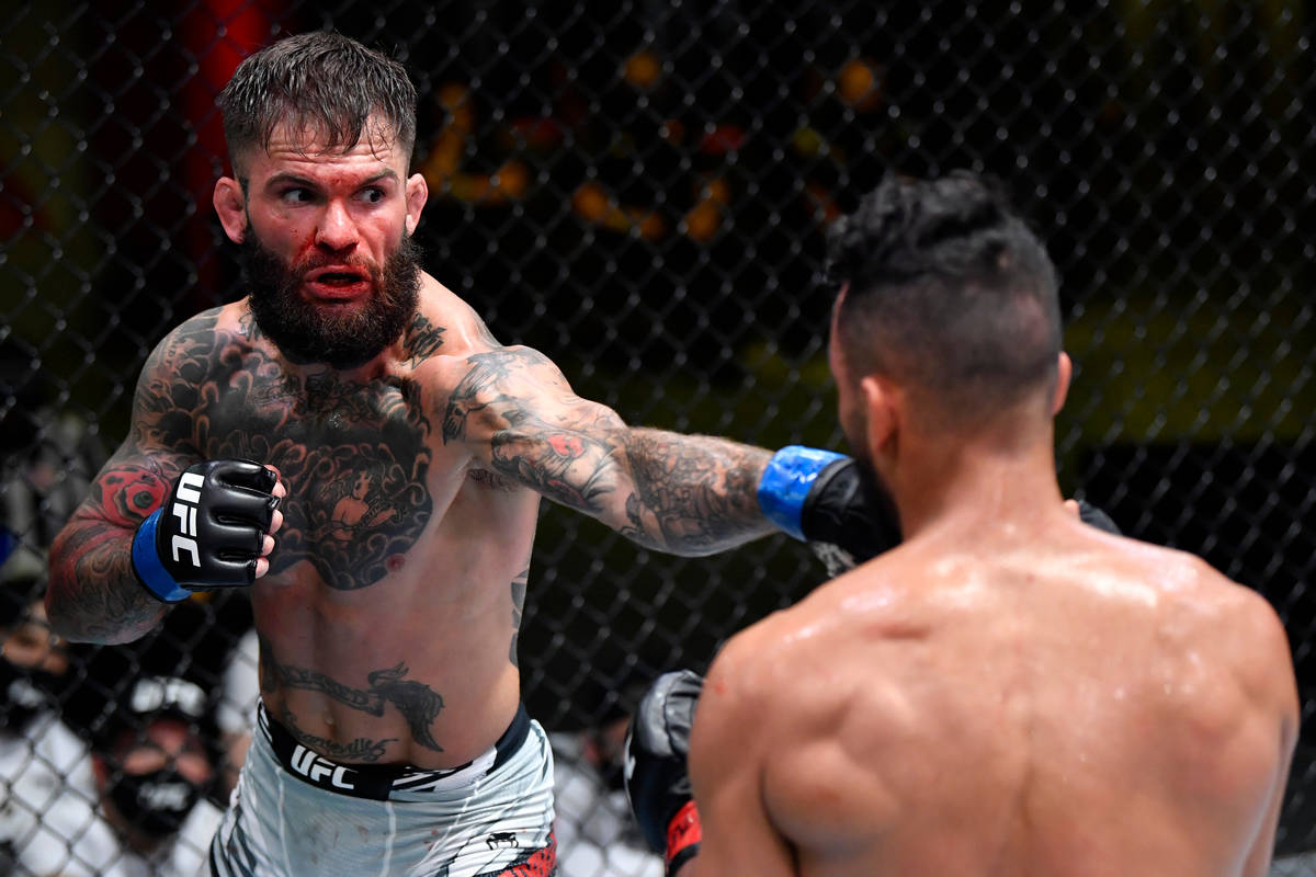 Cody Garbrandt punches Rob Font in their bantamweight bout during the UFC Fight Night event at ...