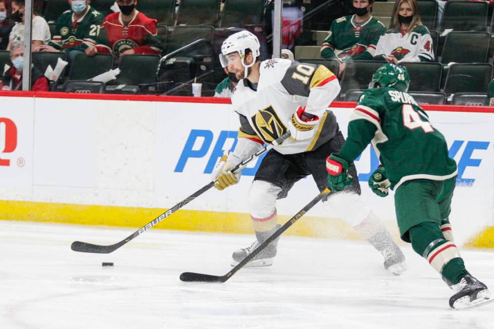 Vegas Golden Knights center Nicolas Roy (10) passes against Minnesota Wild defenseman Jared Spu ...