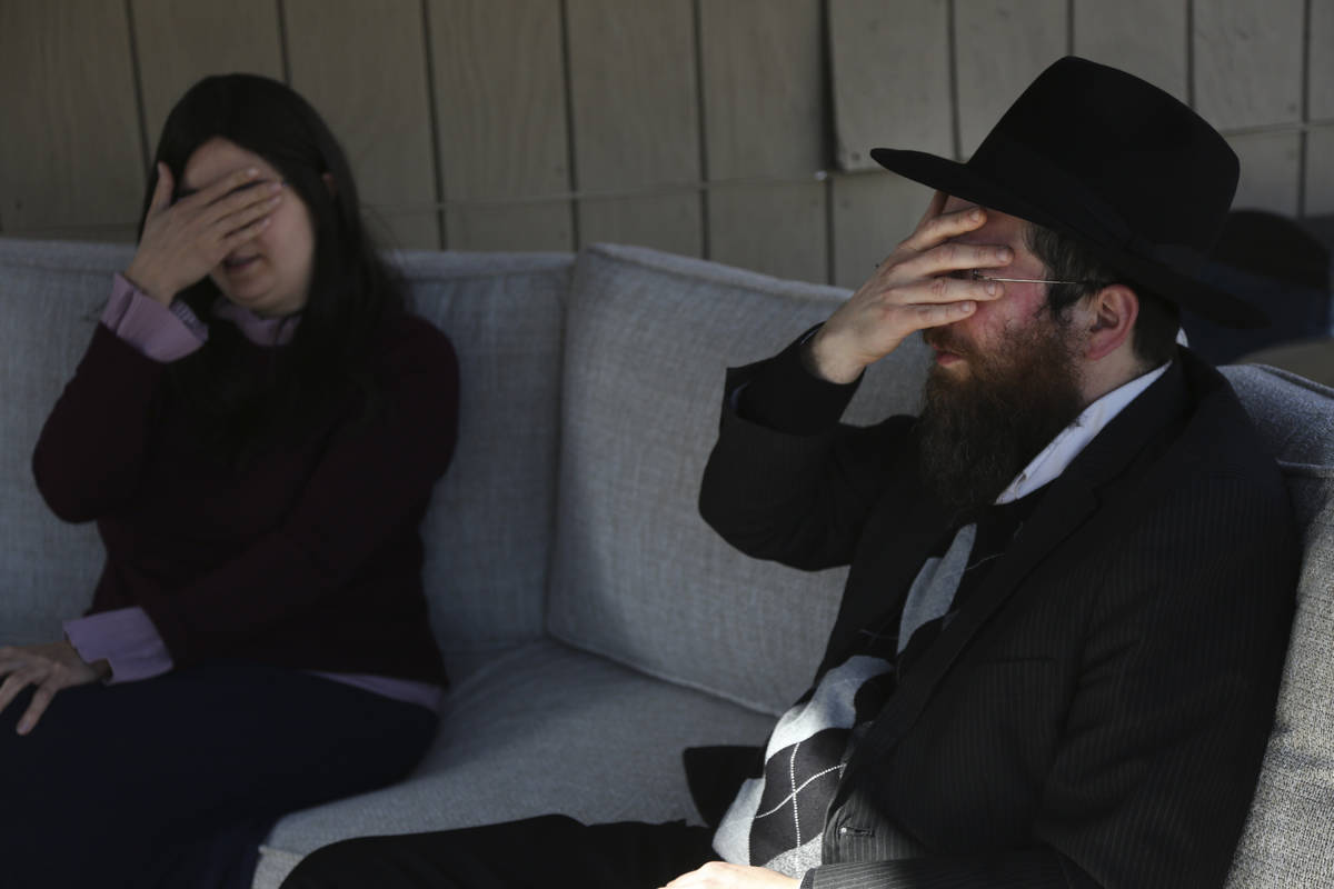 Tzivi Kivman and Rabbi Yossi Kivman recite the Shema, a Jewish prayer, with Michelle and Bob Pe ...
