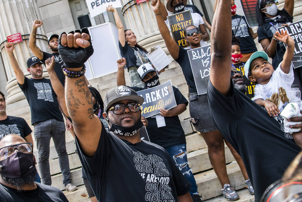 Terrence Floyd, brother of George Floyd, raises his fist with others during a rally on Sunday, ...