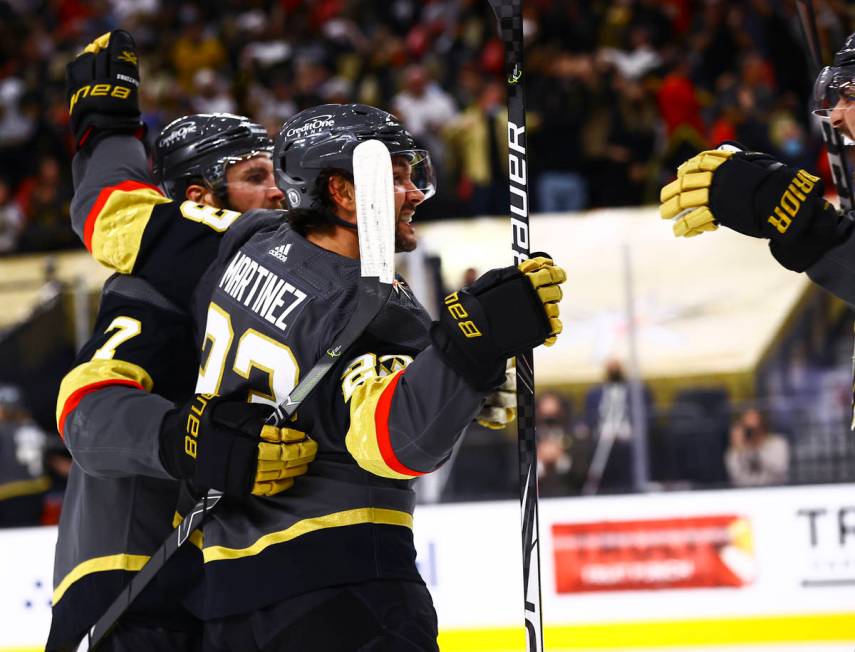 Golden Knights' Alec Martinez (23) celebrates his goal with teammates during the second period ...