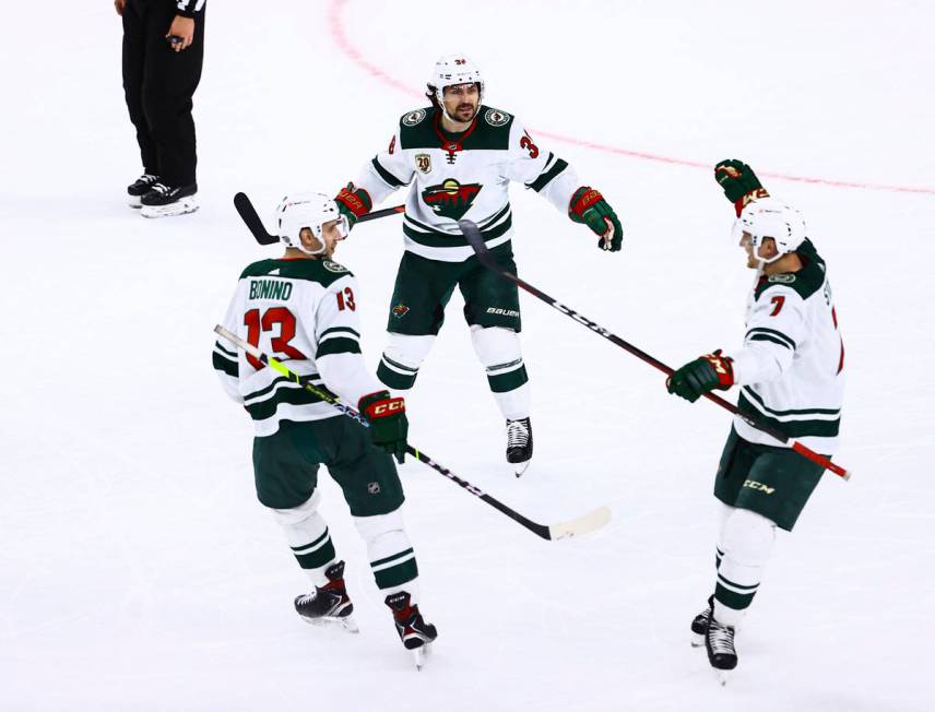 The Minnesota Wild celebrate an empty net goal against the Golden Knights during the third peri ...