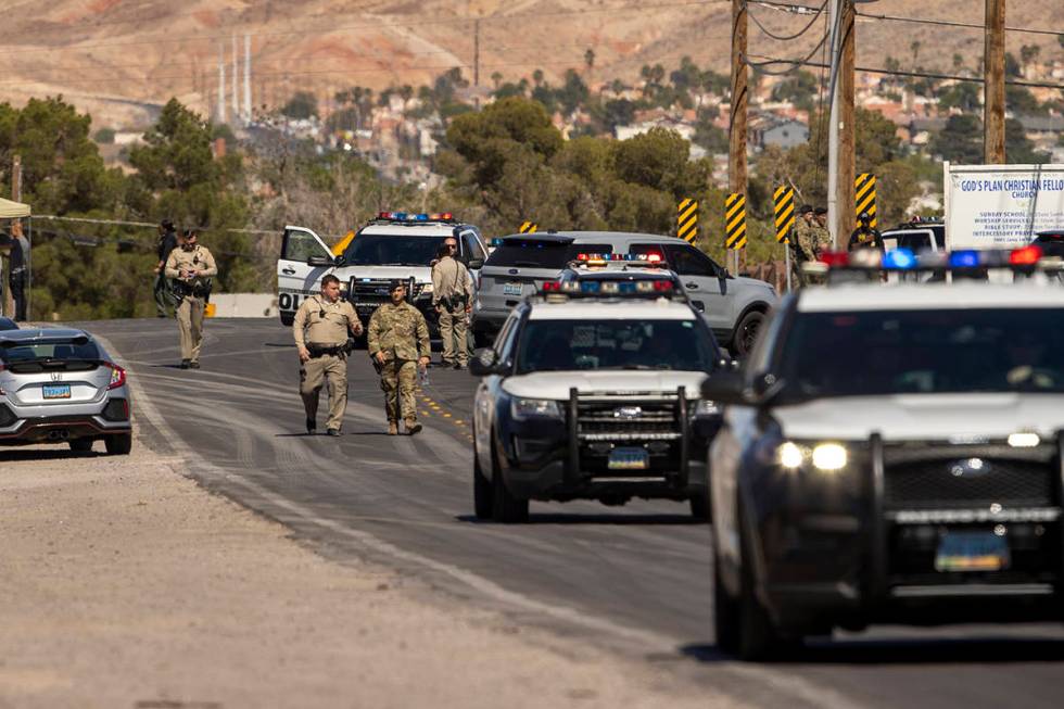 Metro officers and military personnel are near the scene of a Nellis Air Force Base jet crash o ...