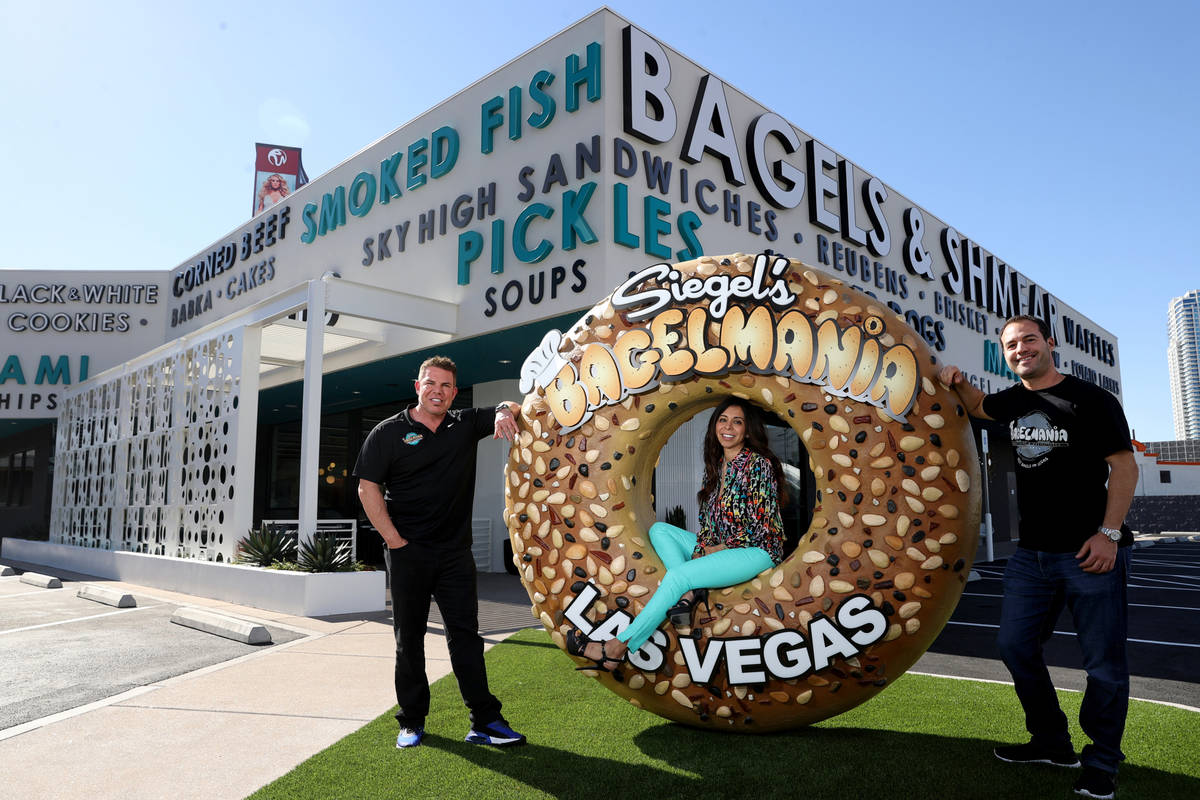 Michael Crandall, senior vice president of The Siegel Group Nevada Inc., right, poses with owne ...