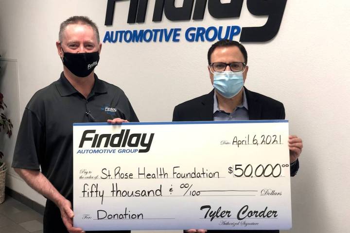 Findlay Automotive Group CFO Tyler Corder, left, makes a $50,000 donation to St. Rose Dominican ...