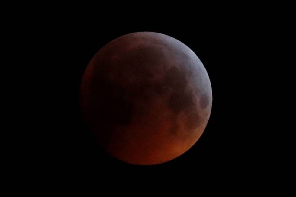 The Earth's shadow falls across the full moon seen above Brighton, southeast England, in Januar ...