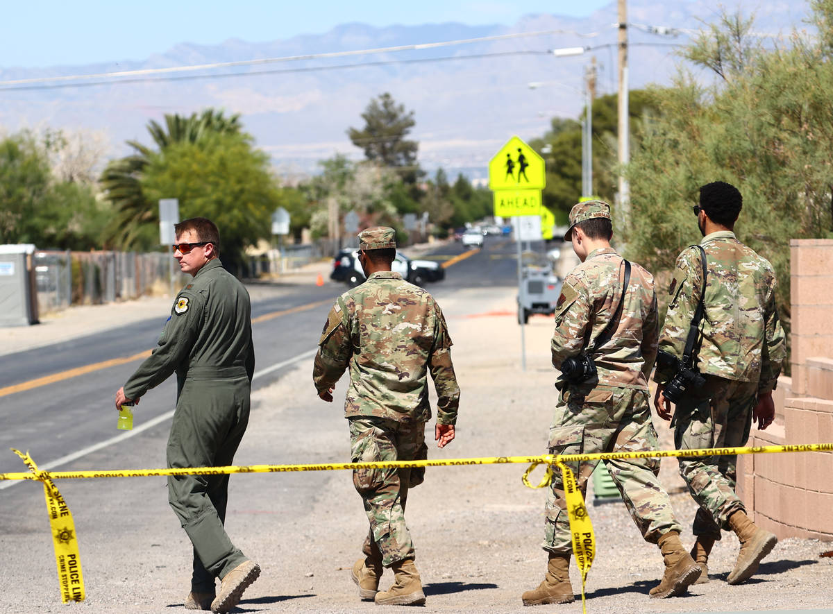 Military personnel investigate an airplane crash near Nellis Air Force Base, on Tuesday, May 25 ...