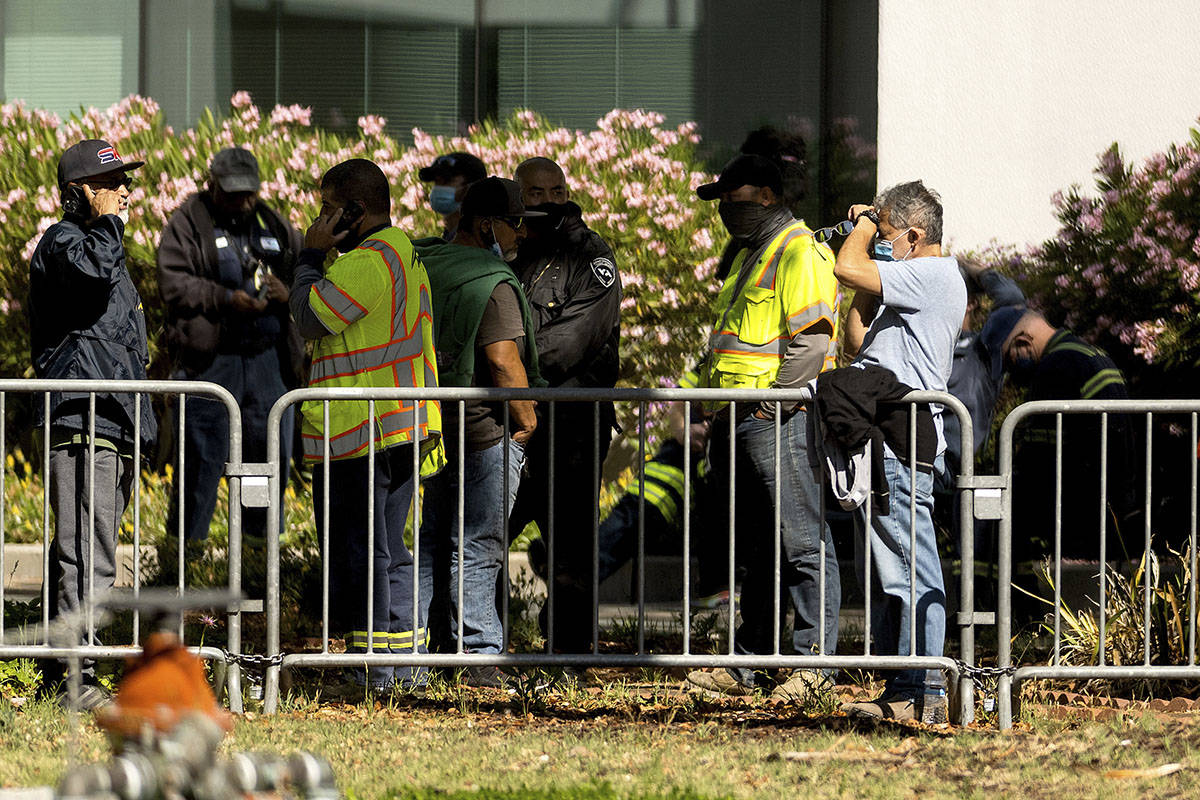 Santa Clara Valley Transportation Authority (VTA) workers gather near a railyard following a sh ...