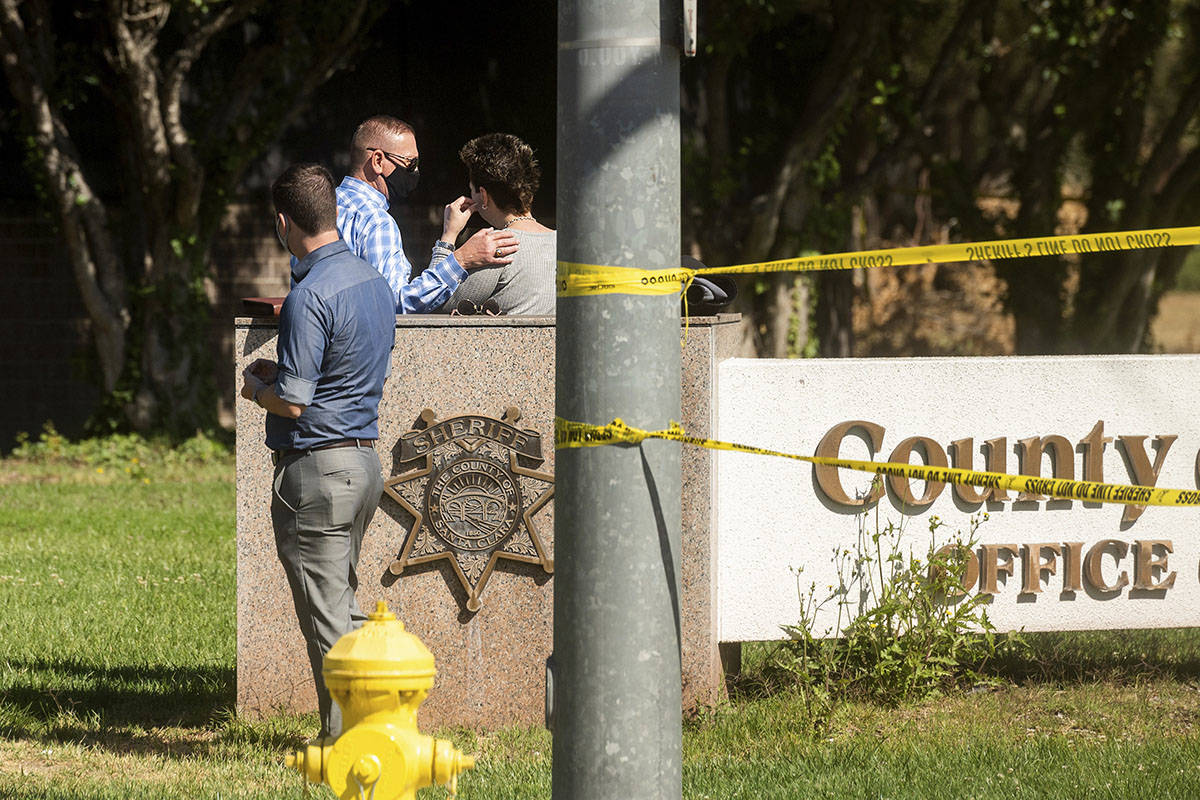 A man comforts a woman near the scene of a shooting at a Santa Clara Valley Transportation Auth ...