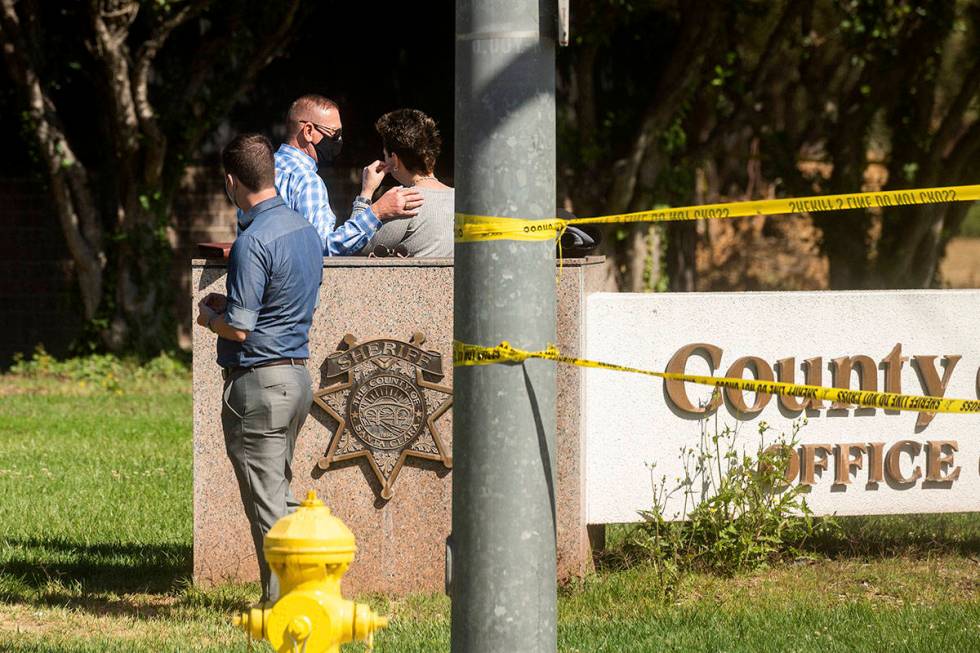 A man comforts a woman near the scene of a shooting at a Santa Clara Valley Transportation Auth ...