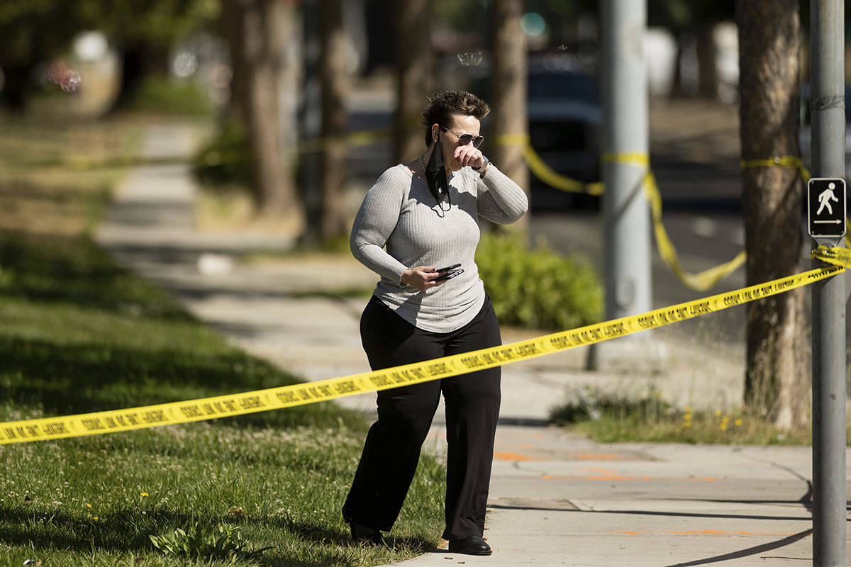 A woman leaves the scene of a shooting at a Santa Clara Valley Transportation Authority (VTA) f ...