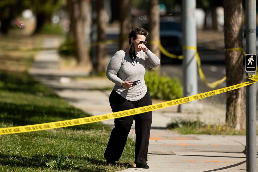 A woman leaves the scene of a shooting at a Santa Clara Valley Transportation Authority (VTA) f ...