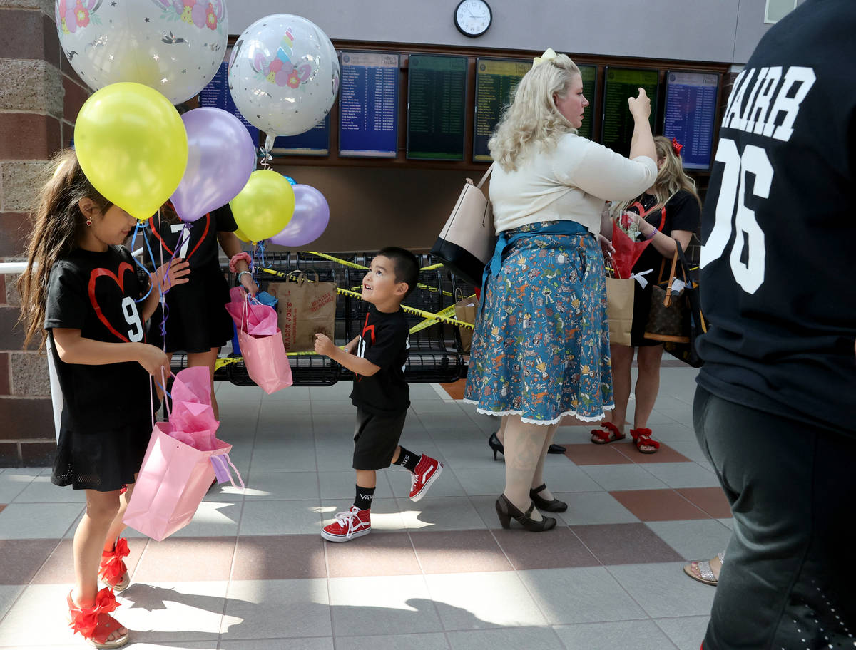 Jacob Heath Hairr, (#11) age 3, takes in the festivities after being officially adopted by Heat ...