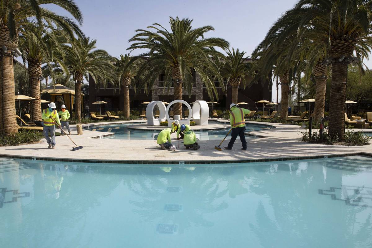 Crews are working at pool area at the Tuscan Highlands apartment complex under construction nea ...