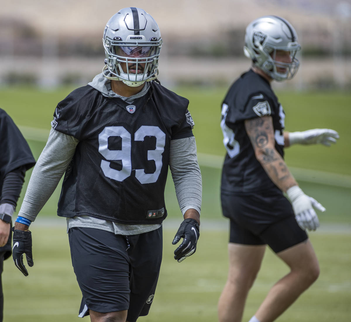 Defensive end Kendal Vickers (93, left) and defensive end Maxx Crosby (98) during a Las Vegas R ...