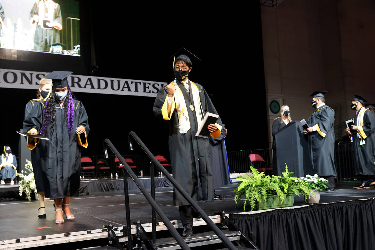 Clark High School student Jonathan Kwok celebrates after receiving his diploma during a graduat ...