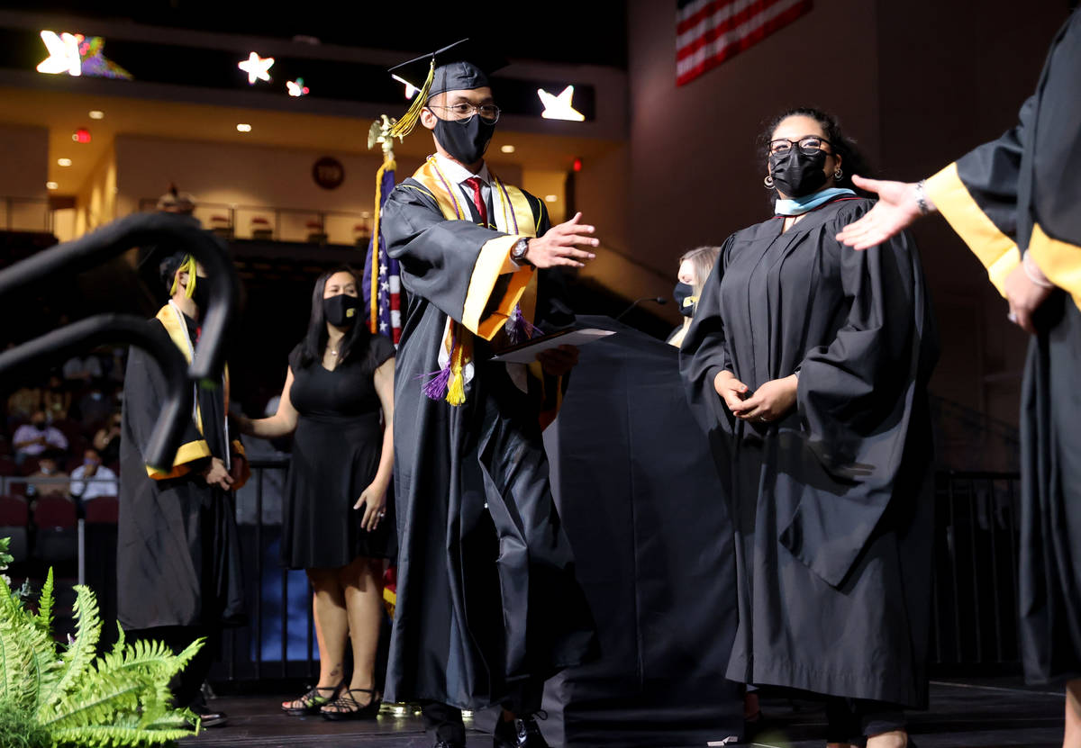 Clark High School student Mark Angelo Yusi walks across the stage after receiving his diploma d ...