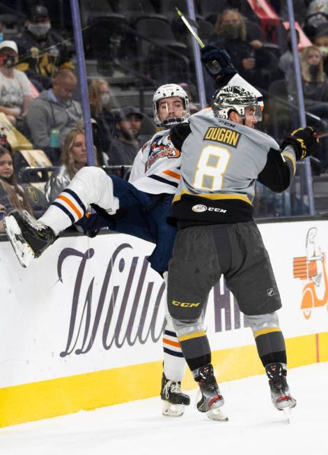 Henderson Silver Knights forward Jack Dugan (8) checks Bakersfield Condors defensemen Philip K ...