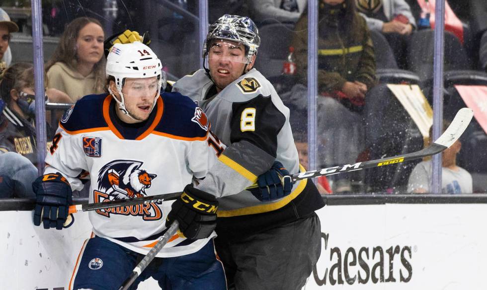 Henderson Silver Knights forward Jack Dugan (8) collides with Bakersfield Condors left wing Dev ...