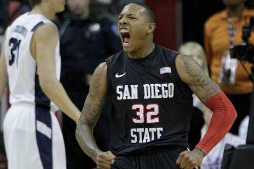 San Diego State's Billy White reacts after scoring against BYU during the first half of an NCAA ...