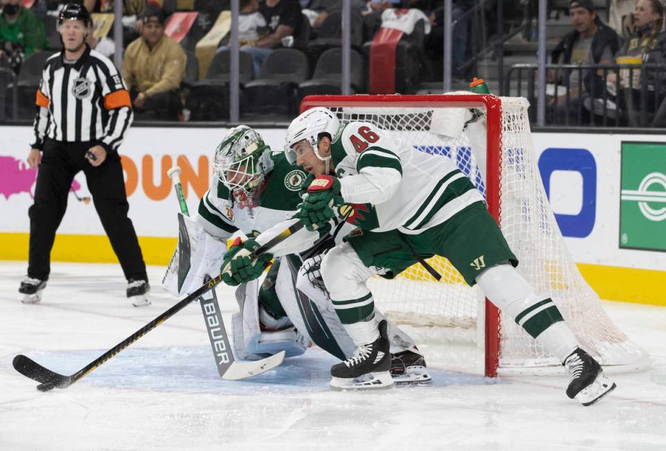 Minnesota Wild goaltender Cam Talbot (33) makes a save with the help of Minnesota Wild defensem ...