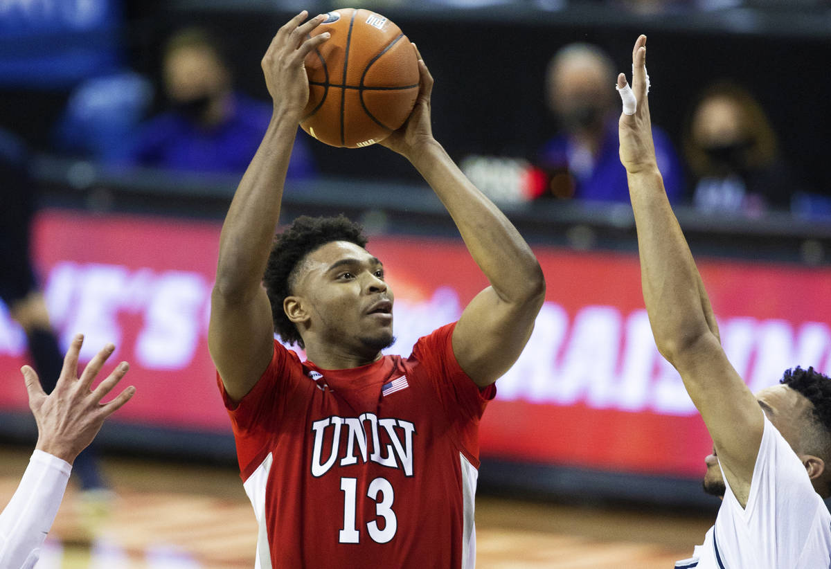 UNLV Rebels guard Bryce Hamilton (13) shoots over Utah State Aggies guard Marco Anthony (44) in ...