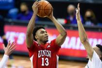 UNLV Rebels guard Bryce Hamilton (13) shoots over Utah State Aggies guard Marco Anthony (44) in ...