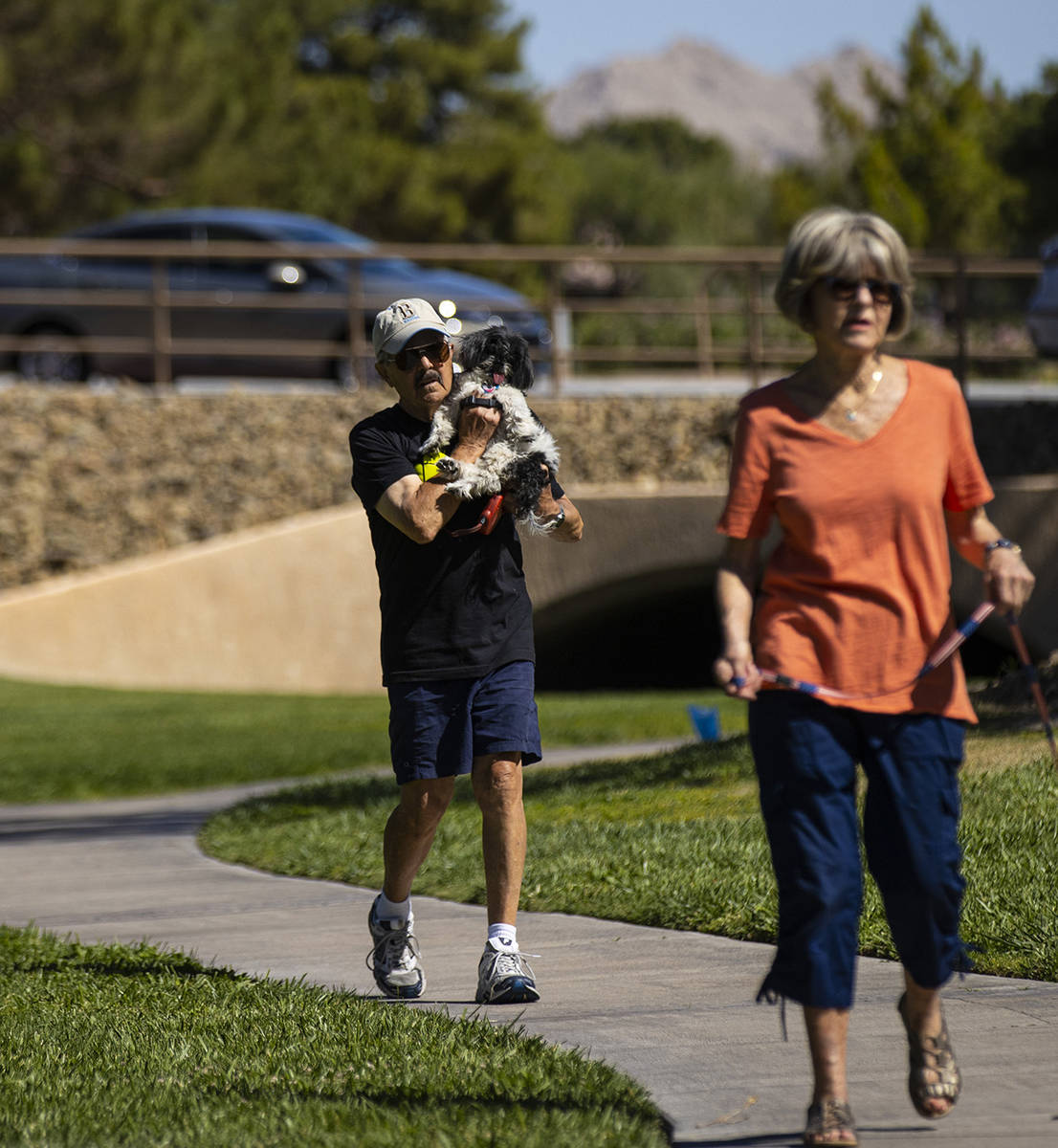 Phil Sardo carries his dog, Mei Mei, in Sun City Summerlin on Friday, May 28, 2021. (Chase Stev ...