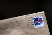 A stamp is shown on an envelope Friday, May 28, 2021, in Washington. The U.S. Postal Service is ...